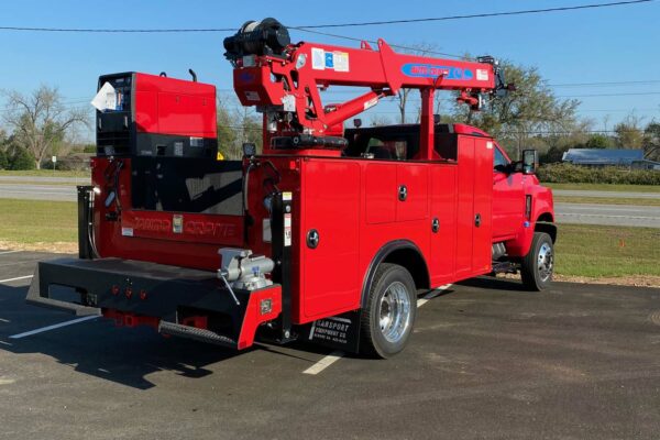 Red truck with crane arm, right rear view
