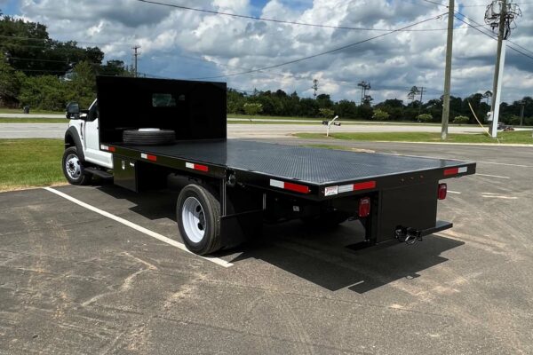 A white truck with a black flatbed