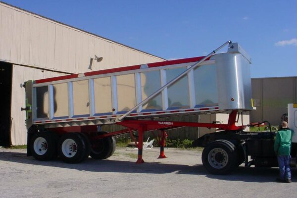 Red and silver dump trailer facing right