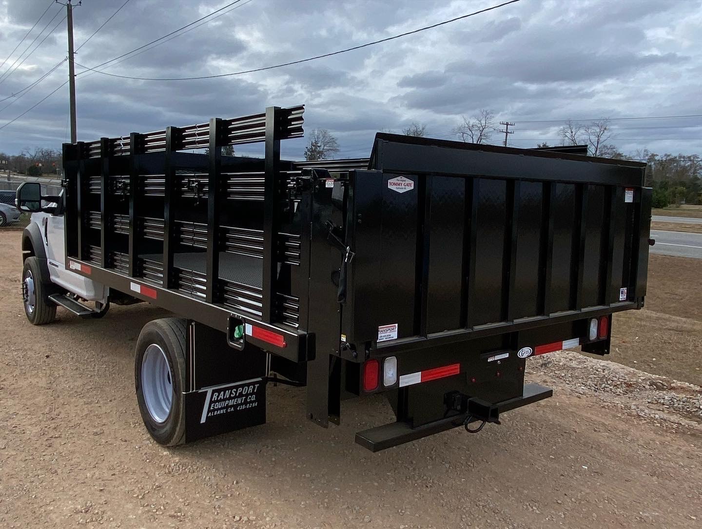 A white truck with a black lift gate