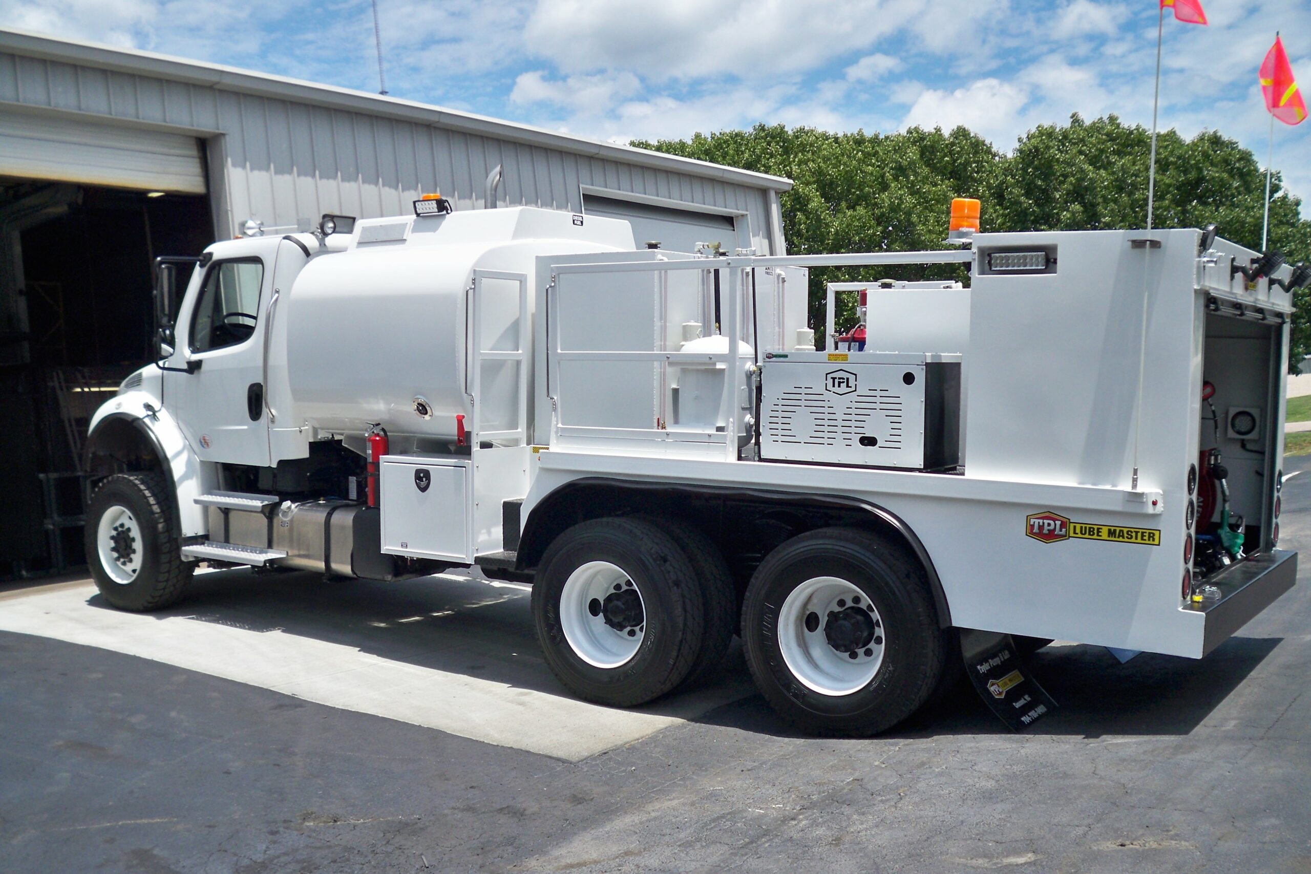 A large white lube system truck facing left
