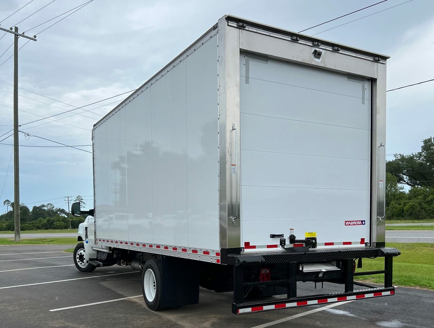 A large box truck viewed from left rear